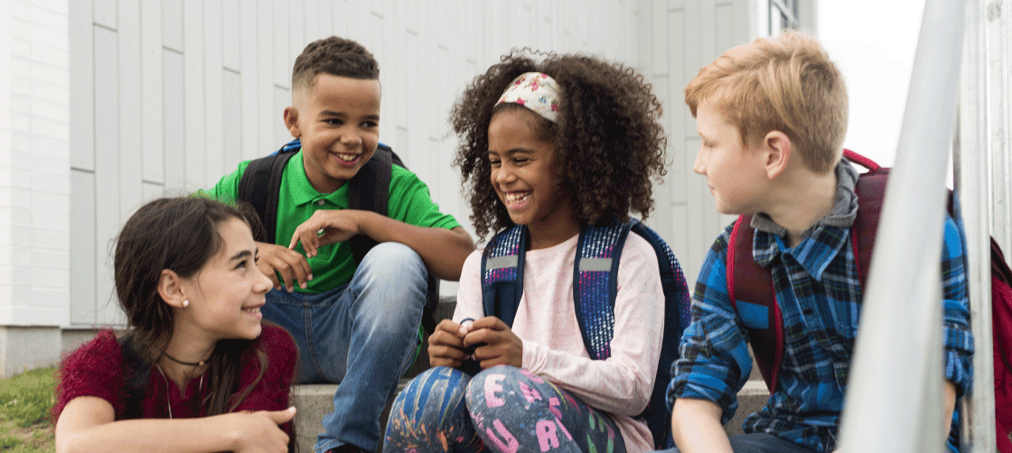 Children sitting on stairs laughing