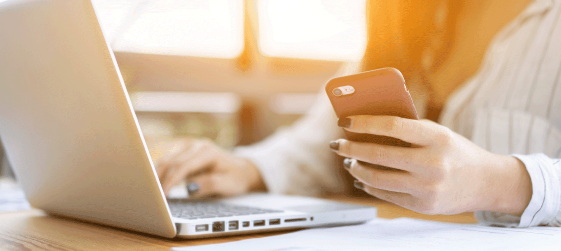 Person on their phone and computer