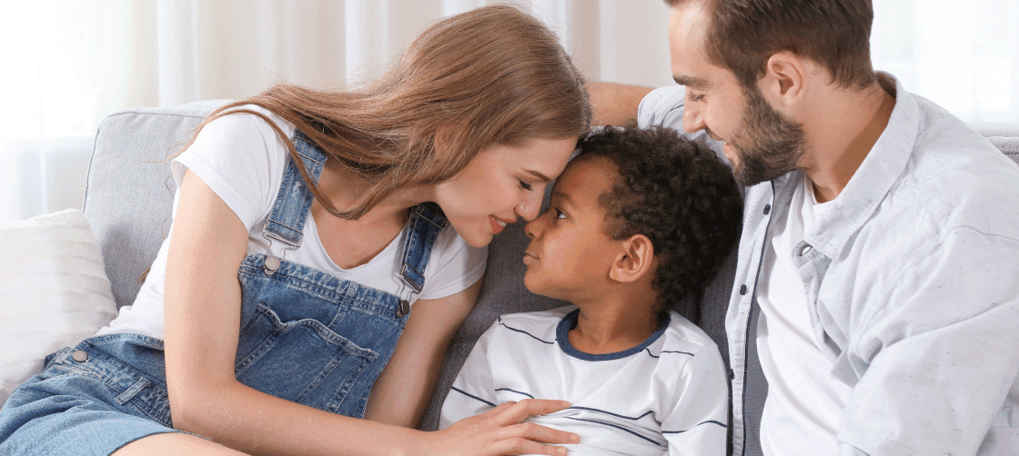 Young couple on the couch with their son